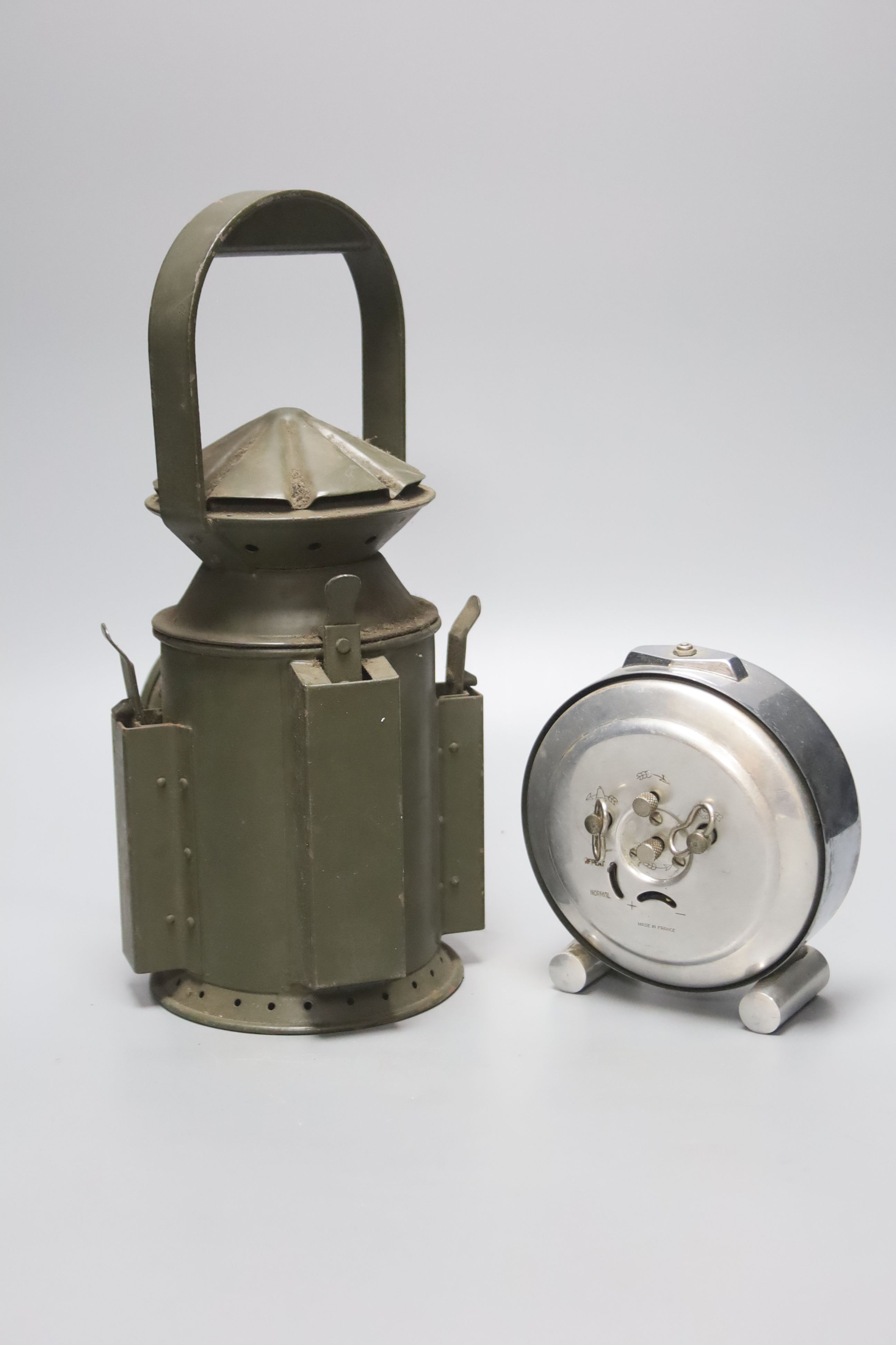 A green painted railway lantern, 30cm high, together with a French chrome cased alarm clock,